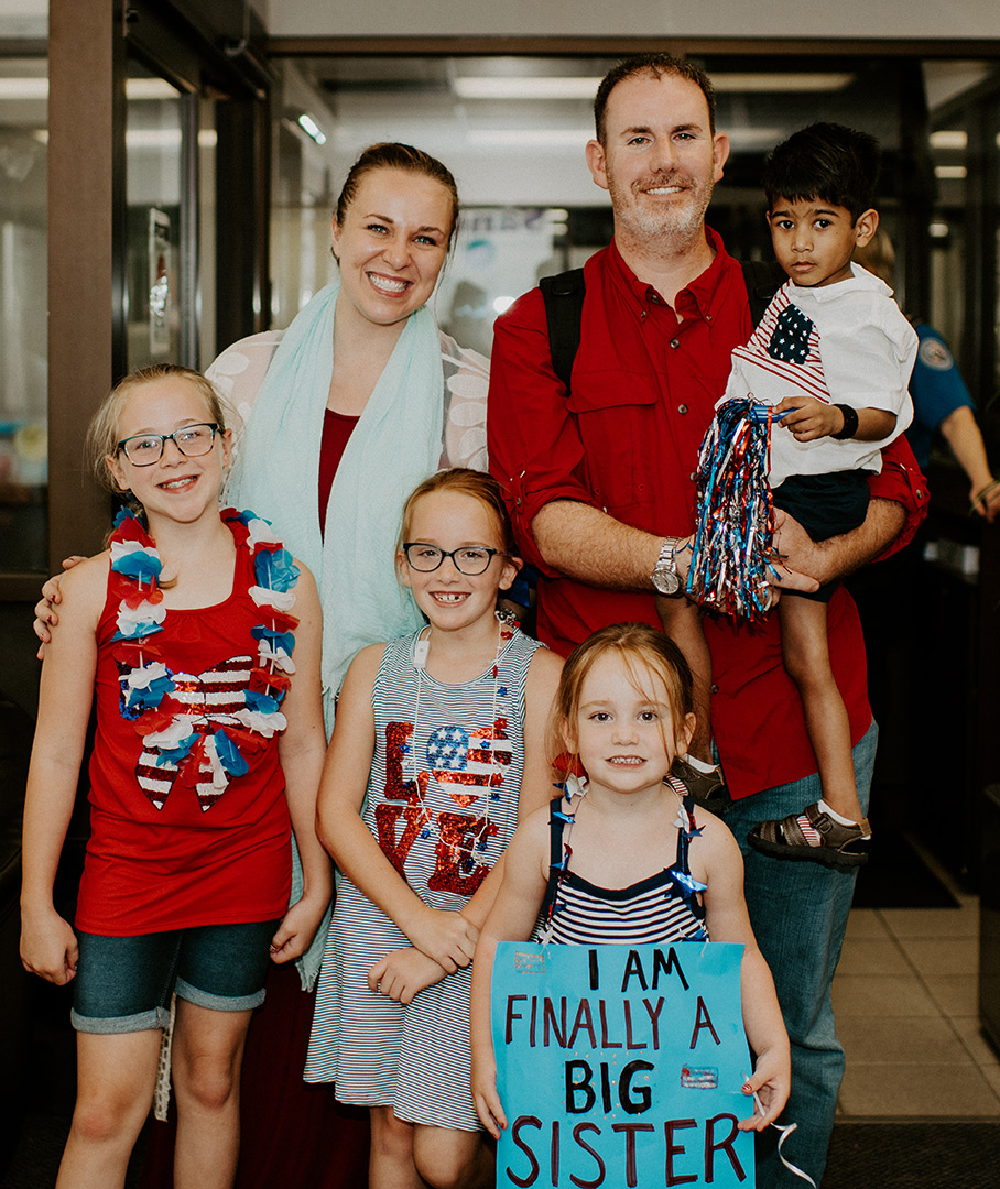 Family welcoming adopted child