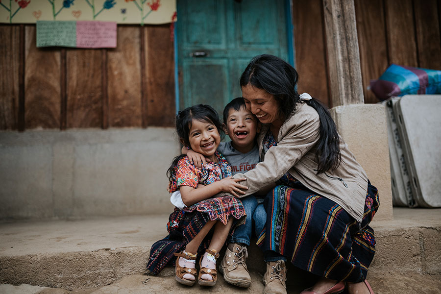 Woman hugging children on street